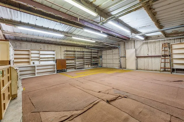 an aerial view of a house with a yard basket ball court and outdoor seating