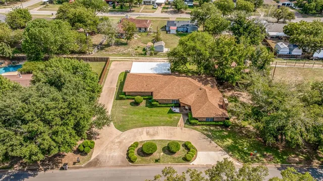 an aerial view of residential houses with city view