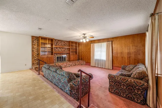 a spacious bedroom with two beds and a window