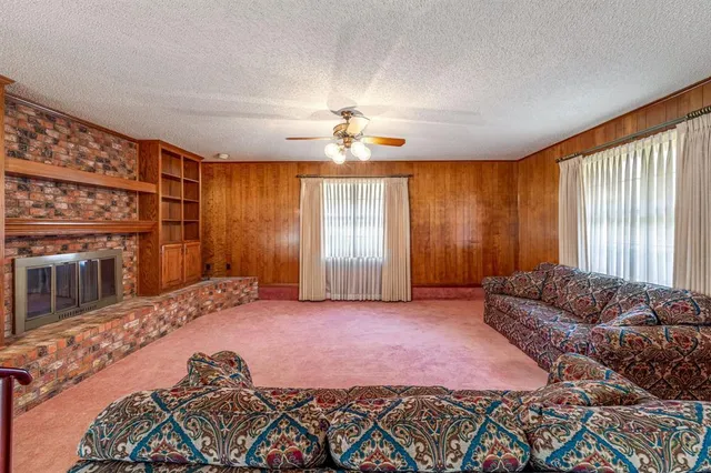 a spacious bedroom with a bed and a chandelier