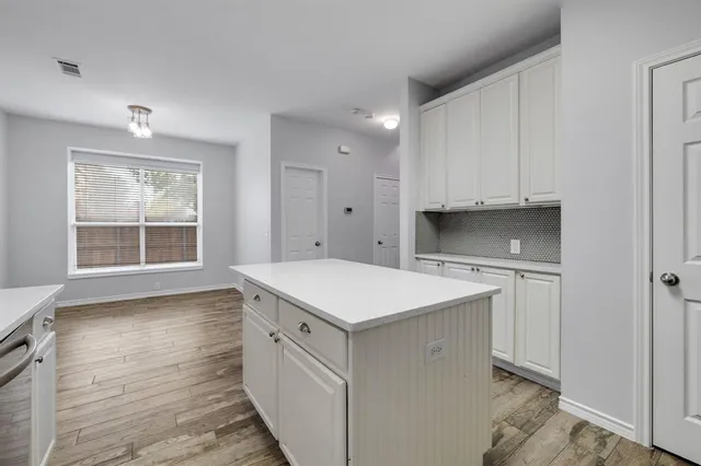 a kitchen with appliances a sink and cabinets