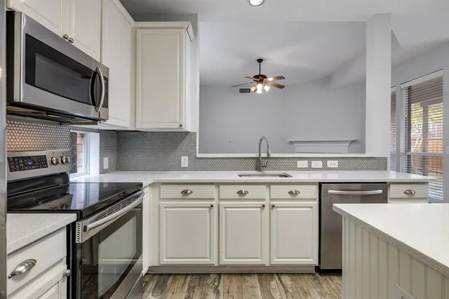 a kitchen with a stove a sink and a refrigerator