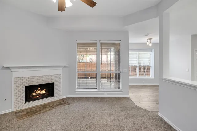 a kitchen with stainless steel appliances a stove top oven a sink a refrigerator white cabinets and wooden floor