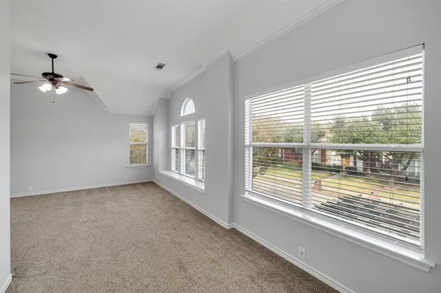 a spacious bedroom with a bed and a couch