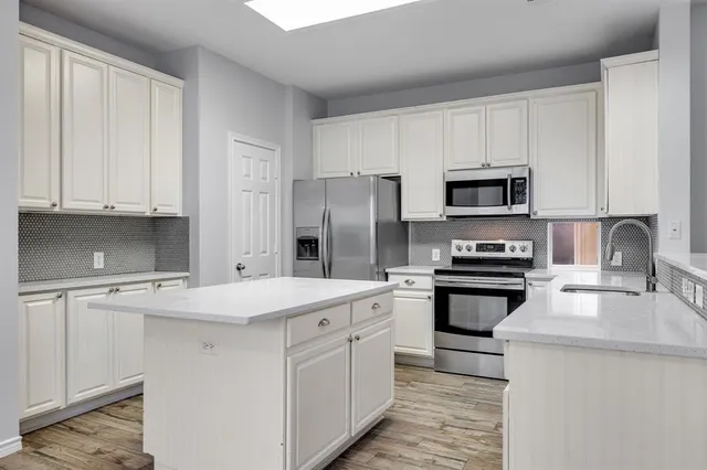 a kitchen with a stove a sink and a refrigerator