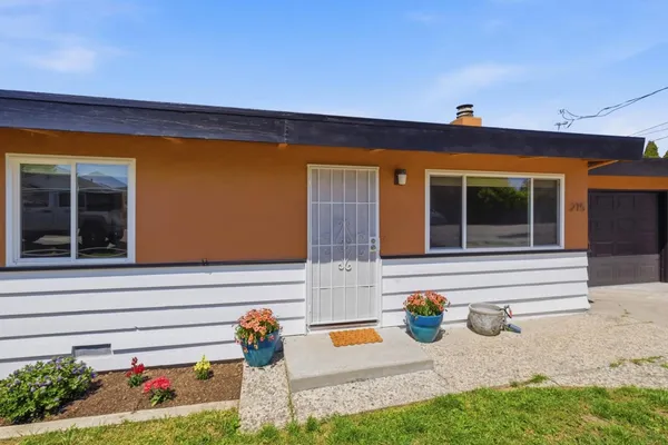 a outdoor view of a house with outdoor seating