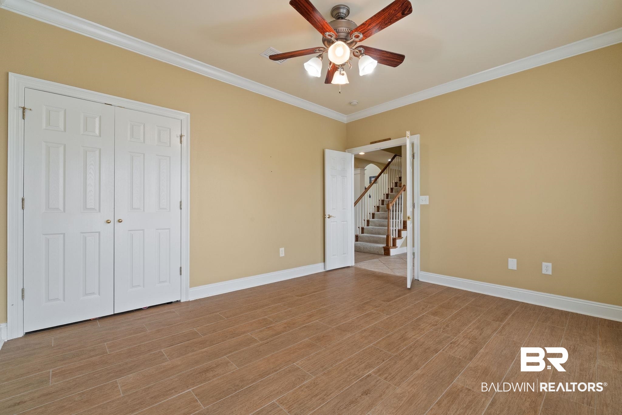 9790 Stucki Road Elberta, AL 36530 - Photo 49 of 72 Unfurnished bedroom featuring light wood-type flooring, baseboards, ornamental molding, and ceiling fan