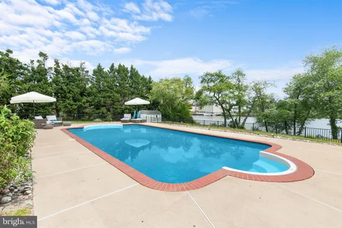 a view of a swimming pool with a yard