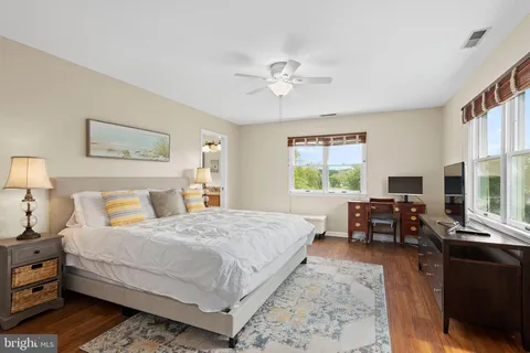 a bedroom with a bed and a large window