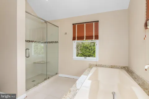a bathroom with a bathtub and shower