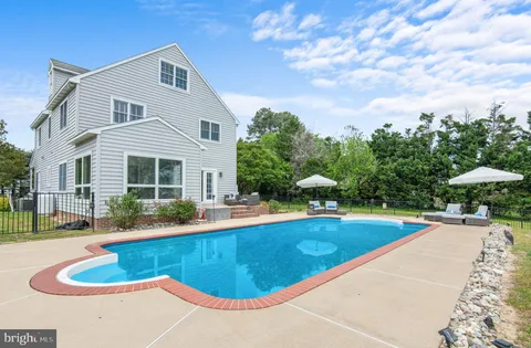 a view of a patio with couches chairs and potted plants
