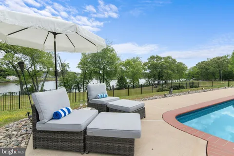 a backyard of a house with lots of green space and tree