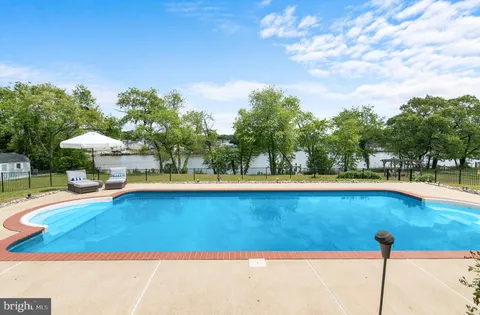 a view of a patio with table and chairs under an umbrella