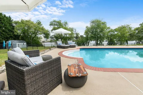 a view of swimming pool with outdoor seating and plants