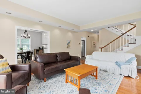 a living room with furniture and a dining table