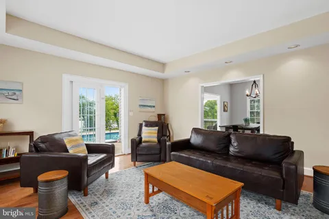 a living room with furniture a rug and a window