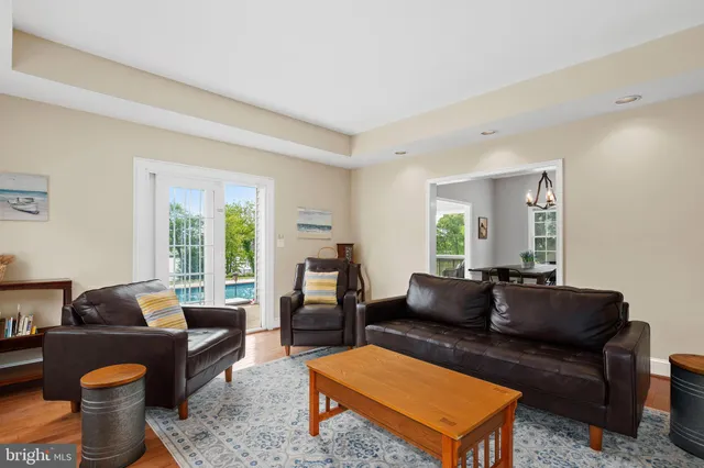 a living room with furniture a rug and a window