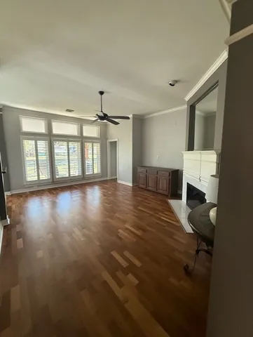a big room with wooden floor and windows
