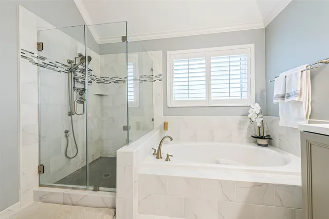 a white bath tub sitting next to a shower