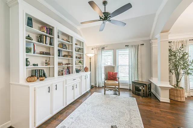 a room with a bookshelf and a window