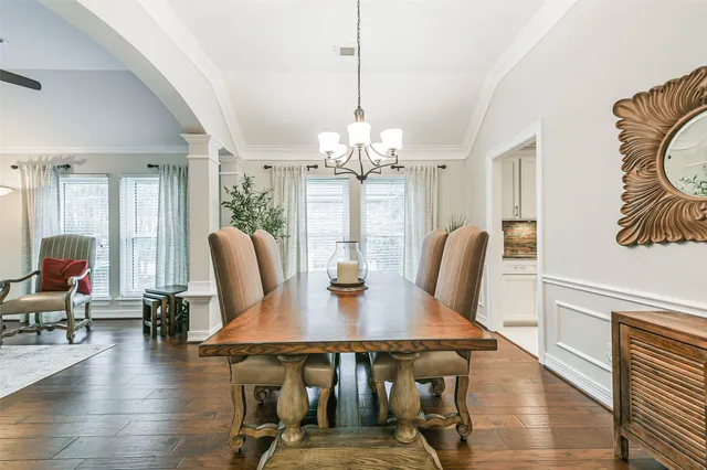 a view of a dining room with furniture wooden floor and chandelier