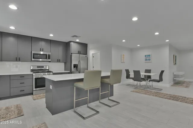 a large kitchen with a table and chairs