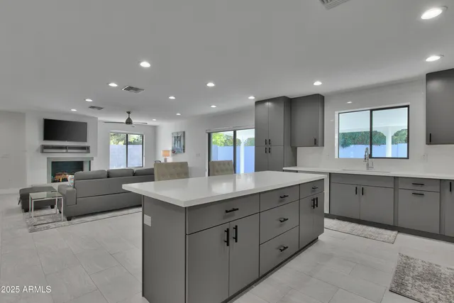 a kitchen with a sink dishwasher a stove and a refrigerator with wooden floor