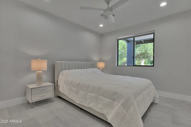 a bedroom with a bed and a lamp