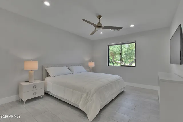 a bedroom with a bed and a window