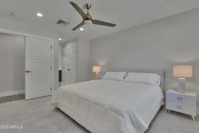 a large white bed in a white room