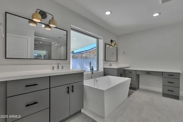 a large white kitchen with a sink and dishwasher with white cabinets