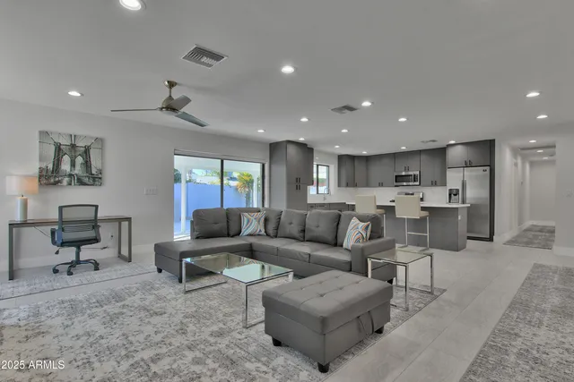 a living room with furniture and a wooden floor