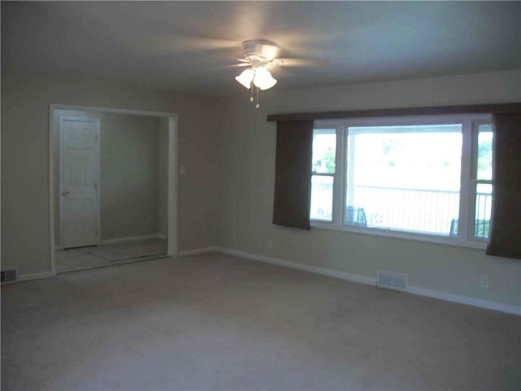 562 Old Waynesburg Road Carmichaels, PA 15320 - Photo 16 of 34 en empty room with windows and chandelier fan