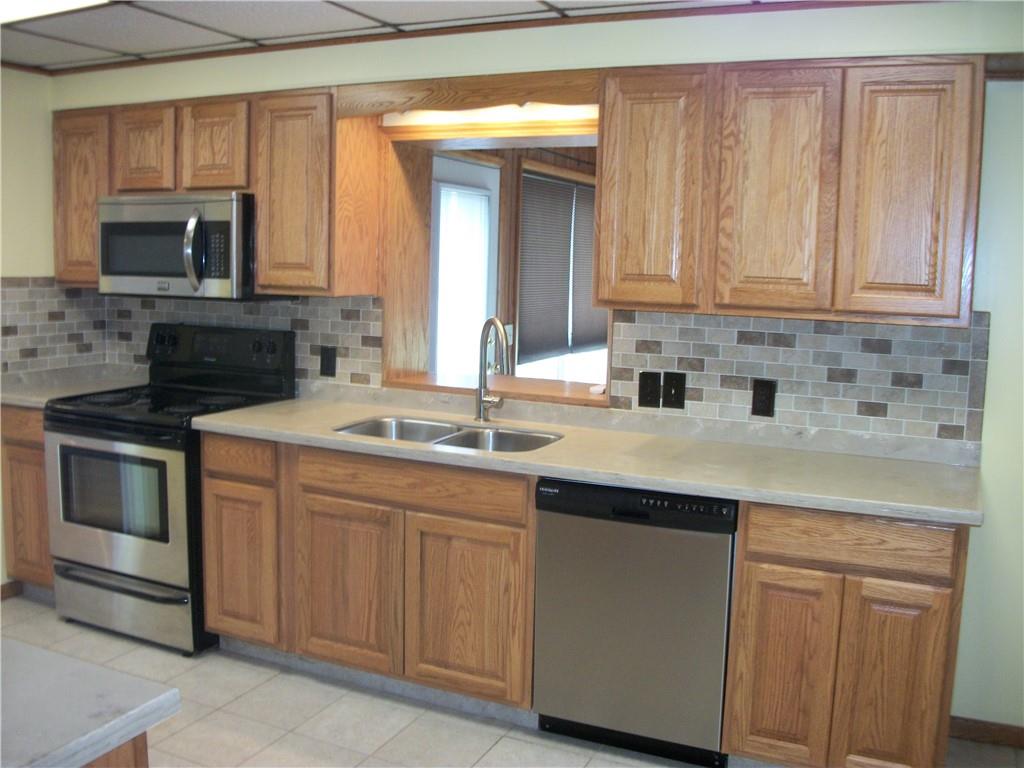 562 Old Waynesburg Road Carmichaels, PA 15320 - Photo 9 of 34 a kitchen with granite countertop a sink and a stove top oven with wooden floor