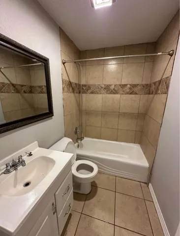 a bathroom with a sink a toilet and bathtub