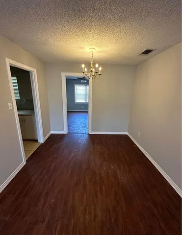 a view of a room with wooden floor