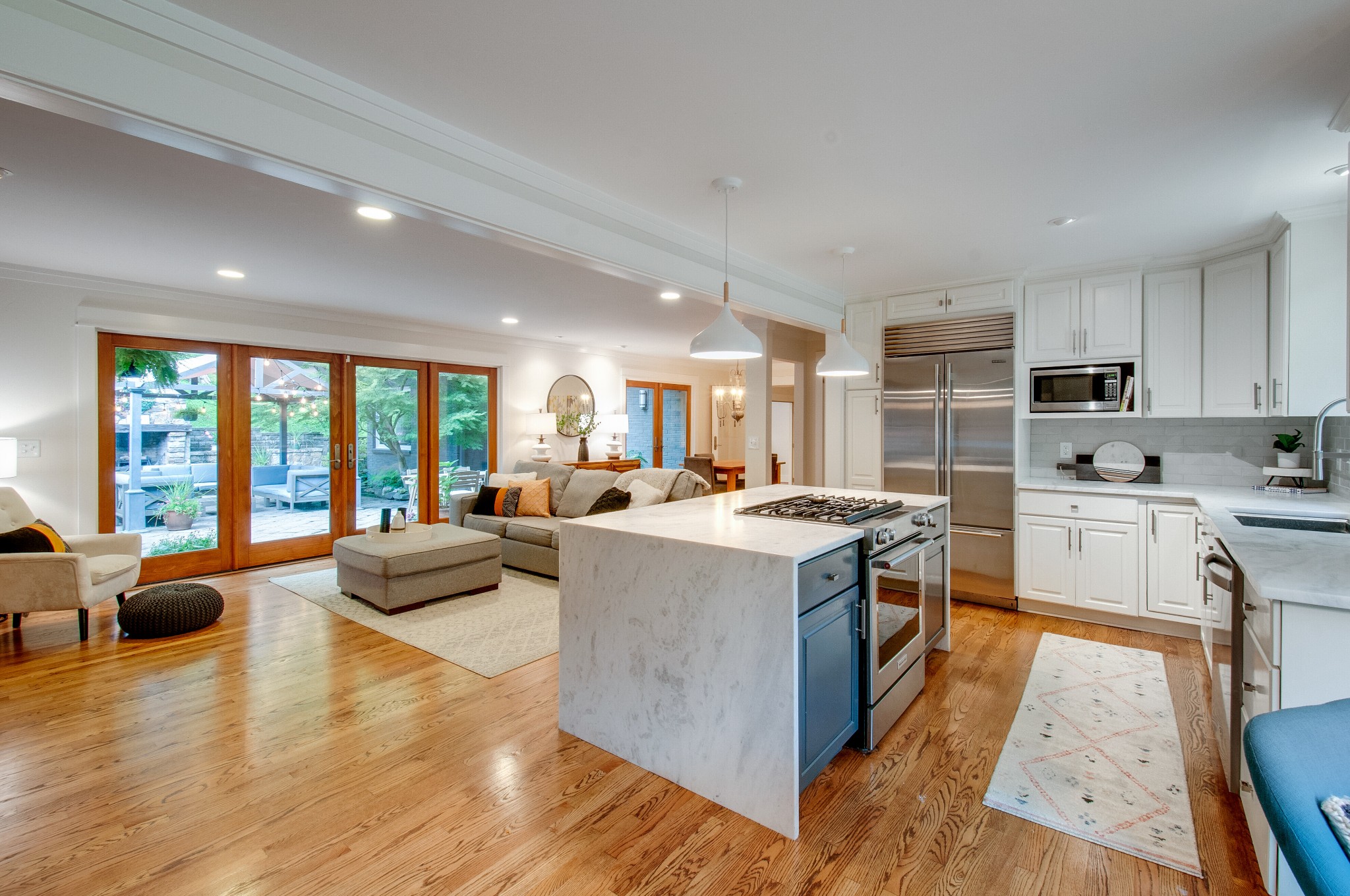 751 Rodney Drive Nashville, TN 37205 - Photo 16 of 50 a large kitchen with stainless steel appliances granite countertop a large kitchen counter top a stove and a sink with couches next to a large window