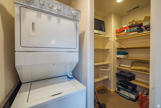 3617 Red Rock Drive Moab, UT 84532 - Photo 78 of 79 Laundry area with stacked washer and clothes dryer and baseboards