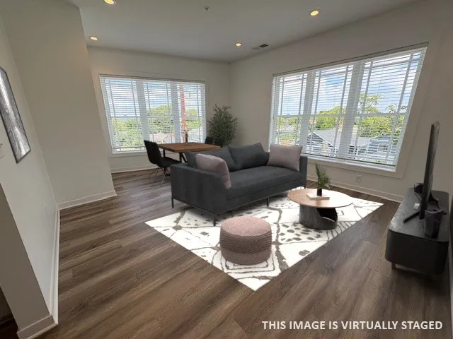 a living room with furniture and a large window