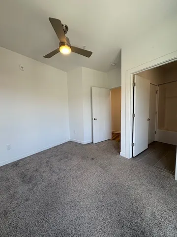 a view of a livingroom with a ceiling fan and window