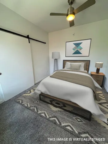 a bedroom with a bed and a painting on the wall