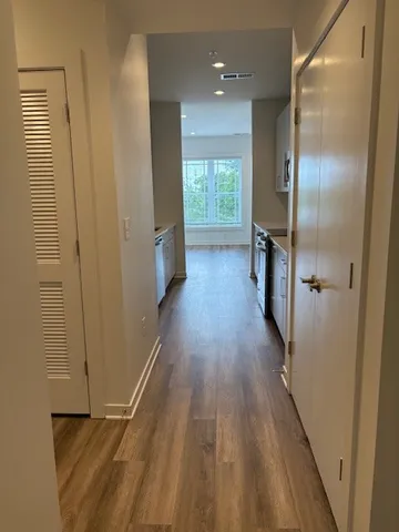 a view of a hallway with wooden floor