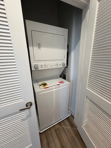 a view of washer and dryer with wooden floor