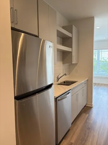 a kitchen with a refrigerator and a sink