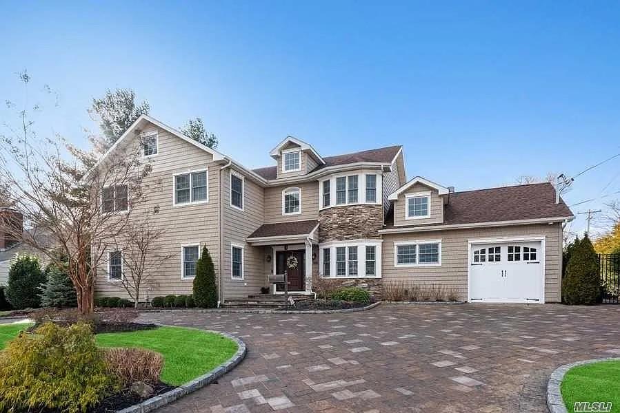 261 Channon Road Hewlett Harbor, NY 11557 - Photo 1 of 1 View of front facade featuring a garage
