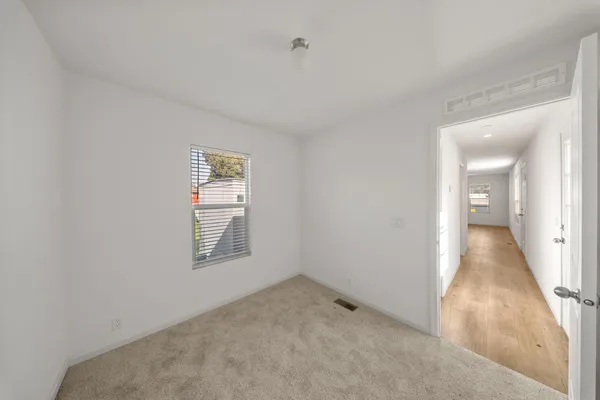 an empty room with windows and closet