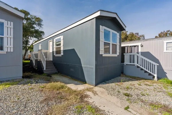 a view of a house with wooden fence