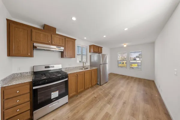 a kitchen with stainless steel appliances granite countertop a stove and a refrigerator