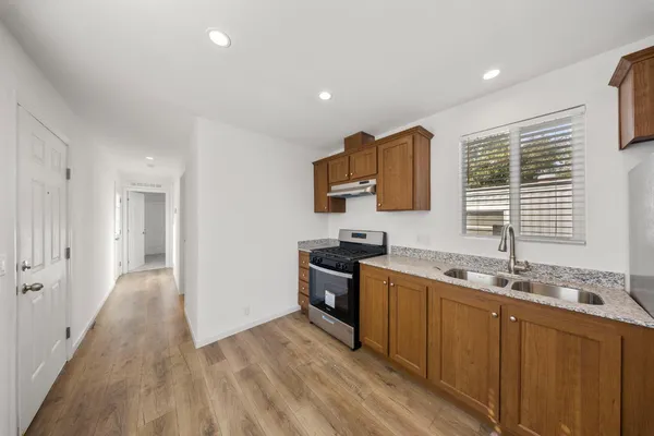 a kitchen with a sink a window and stainless steel appliances