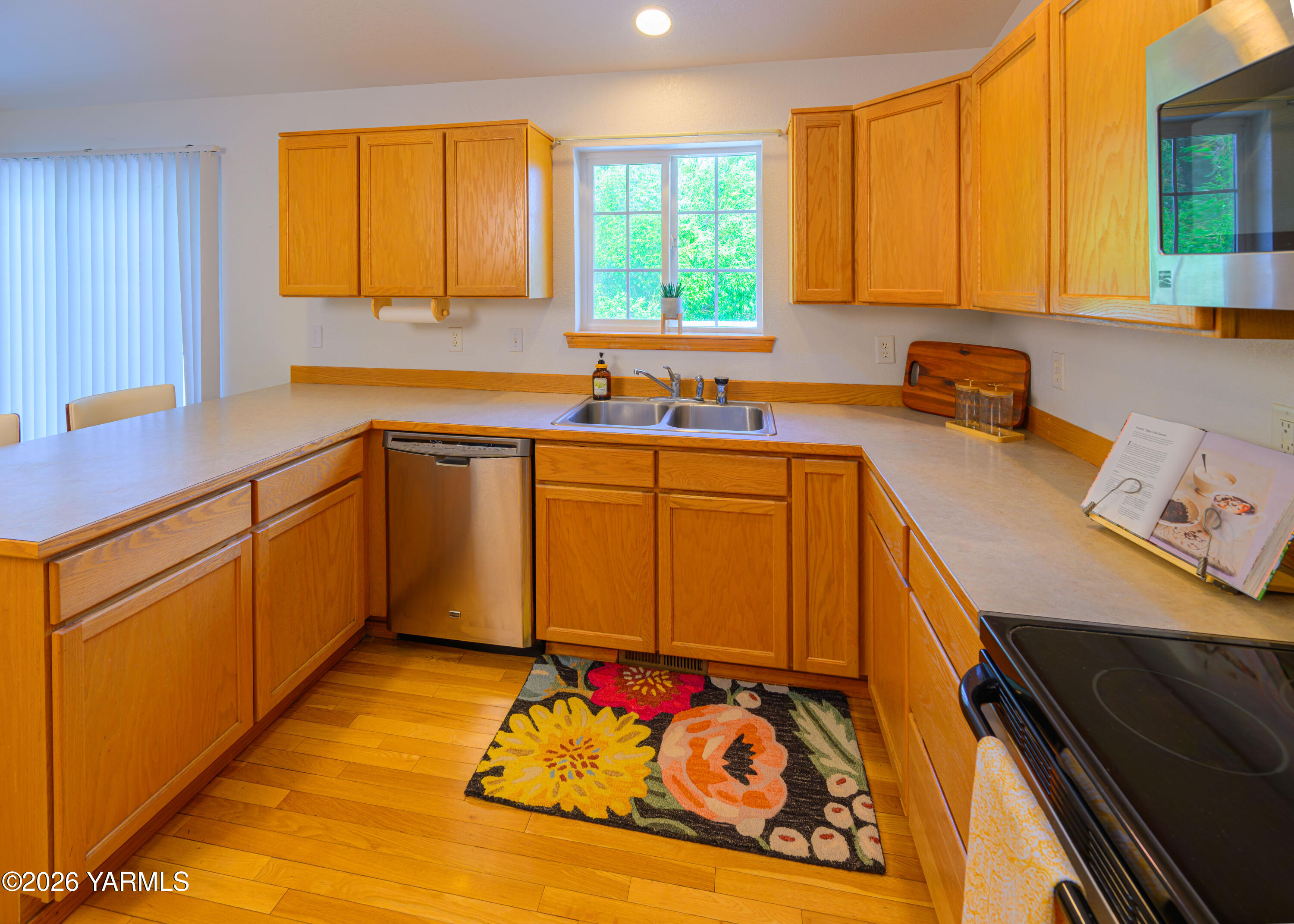 115 Lyle Loop Selah, WA 98942 - Photo 8 of 42 a kitchen with stainless steel appliances wooden cabinets a sink and a stove